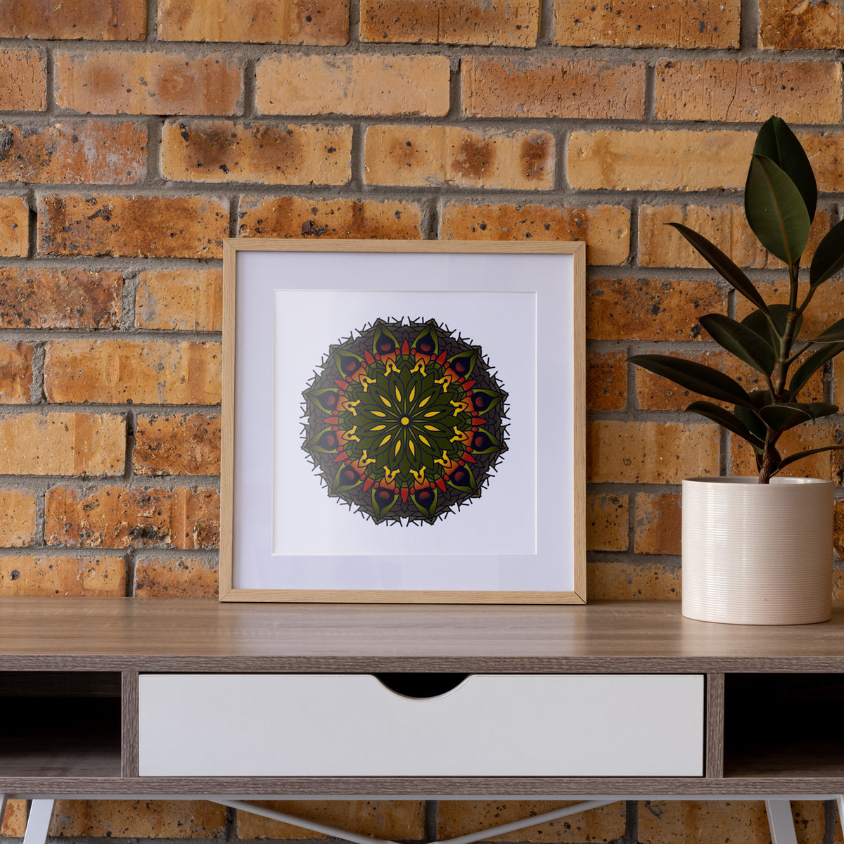 The Hunger for Light fine art print in natural wood frame on console against exposed brick wall